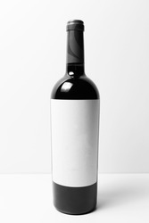 Close-up of simple bottle of wine with mockup, empty blank, on white background.