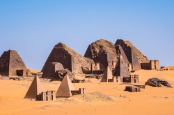 Nubian pyramids of Meroe in Sudan, big pyramids tombs near the river Nile on the east bank in the Sahara desert. Travel to Sudan and discover the pyramid of Meroe in Northern Africa
