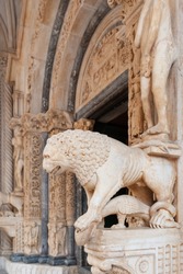 Lion statue at at exquisitely carved West portal of medieval Cathedral of St. Lawrence in Trogir, Croatia