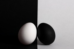 black egg lies on white background white egg lies on black background