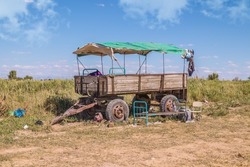 An old abandoned tractor cart on wheels at a field camp.