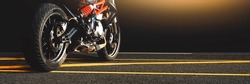 Motorcycle parked alone on a asphalt road in the night time,horizontal copy space,Motorbike panoramic banner concept