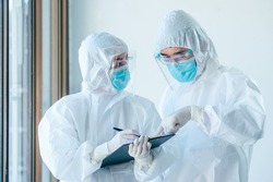 Two asian doctor wearing personal protective equipment or PPE working on quarantine patient infected coronavirus (covid-19), Teamwork medical staff during the epidemic crisis coronavirus.