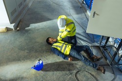Supervisor first aid help injured worker accident electric shock unconscious. Asian electrician worker accident electric shock unconscious in site work.