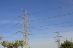High voltage power transmission towers Have a complex steel structure. high-voltage power lines near palms tree, high voltage electric transmission tower