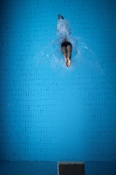 man jumping in pool