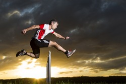 athlete in hurdling in track and field in sunrise