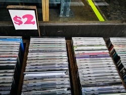 Secondhand CD music albums sale for 2 dollars each.