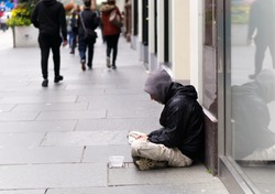 An unidentified homeless man begging on city street in Glasgow, Scotland.