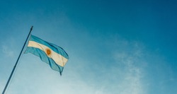 Argentina flag waving on a sunny day against blue sky