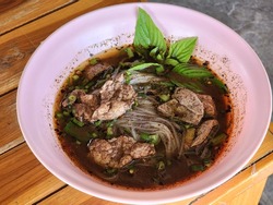 Thai Boat noodles soup or Guay tiew reua ,Rice noodles thicken soup with stewed pork , pork ball ,Braised pork and liver pork ,Thai boat noodles is Thailand's most famous noodles soup,
Thai local food