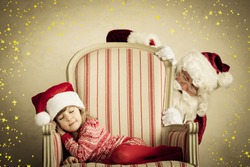 Santa Claus and sleeping child. Children dream. Christmas holiday concept. Xmas miracle