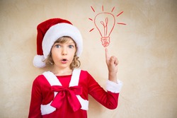 Surprised child in Santa hat. Christmas holiday concept