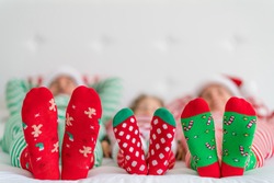 Happy family lying on bed. Mother; father and child having fun in Christmas time. Man, woman and kid relaxing at home. Winter holiday Xmas and New Year concept