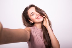 Young happy smile girl take selfie on white background