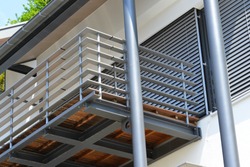 Balcony with Handrails of high-grade Steel in Front of a modern residential Building