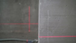 Lighted laser level. Laser level flooring. Leveling the wall with a laser level.Display perpendicular lines. Laser on the walls in preparation for leveling the floor.