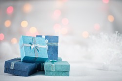 Blue gift boxes on the white fur with copy space for season greeting Merry Christmas or Happy New Year.