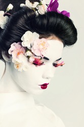 Portrait of young woman decorated in japanese style. Geisha girl