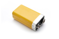 A blank yellow 9v battery isolated on white background