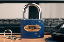 Digital services act (DSA) concept: lock with European Union Flag near to a computer.