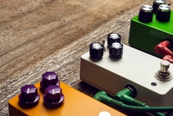 Three guitar pedals effects on wooden floor