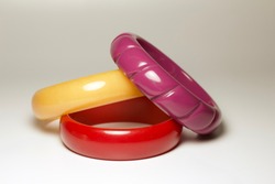 Close up view of colorful vintage bakelite (baekelite) bangle bracelets on white background with copy space
