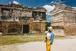 Girl tourist walks through the ancient Mayan complex Chichen Itza.A popular tourist destination in the Yucatan - Chichen Itza complex 
