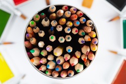Large set of colored pencils pointing up - top view