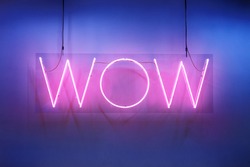 Neon shine electricity fluorescent sign “Wow” concept illuminated vintage retro club glow icon logo text light WOW billboard signboard trend funny entertaining emotion nightlife in pink blue colors