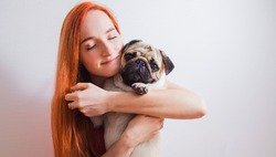 The young woman has a great time with her favorite pug