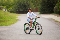 Teenage boy is riding on a bicycle
