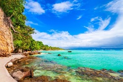 Promenade at the rocky beach with turquoise water in Boracay island in Philippines