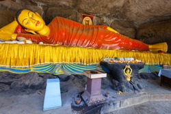Reclining Buddha statue at the foot of Adams Peak. Adams Peak or Sri Pada is a tall and holy mountain in Sri Lanka.