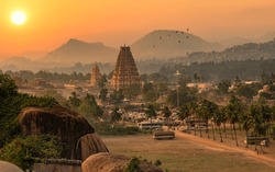 Historic Virupaksha temple with scenic Hampi landscape and cityscape at sunset at Karnataka India