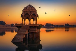 Ancient temple ruins at Gadi Sagar lake Jaipur Rajasthan at sunrise 