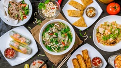 Assorted asian dinner, vietnamese food. Pho ga, pho bo, noodles, spring rolls