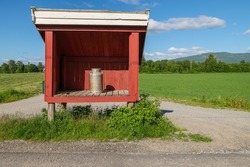 Milk can in a wooden shelter with letterbox at a farm near Hamar, Norway. Seen on the pilgrimage path St. Olavsweg, Gudbrandsdalsleden.