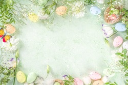 Spring Easter holiday top view  flat lay background with eggs in nests and spring flowers. Greeting card background with copy space.