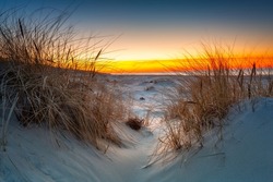 Beautiful scenery of the Baltic Sea beach at sunset, Slowinski National Park, Leba. Poland