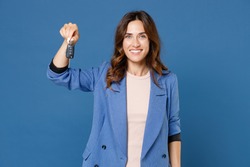 Smiling cheerful beautiful attractive young brunette woman 20s in basic casual jacket standing holding in hand car keys looking camera isolated on bright blue colour wall background studio portrait