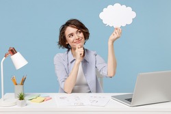Young successful employee business woman in shirt sit work at white office desk with pc laptop empty blank Say cloud speech bubble promotional content prop up chin isolated on blue background studio