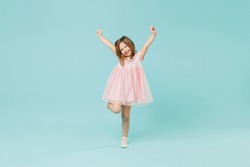 Full size body length little fun cute kid girl 5-6 years old wears pink dress dancing isolated on pastel blue color background child studio portrait. Mother's Day love family people lifestyle concept