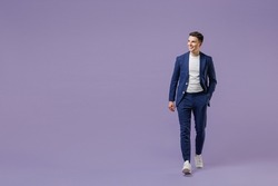Full size fun young successful employee business man lawyer 20s wears formal blue suit white t-shirt work in office move hand in pocket look aside isolated on pastel purple background studio portrait