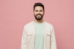 Young smiling happy cheerful friendly fun european caucasian man 20s wearing trendy jacket shirt look camera isolated on plain pastel light pink background studio portrait. People lifestyle concept