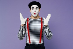 Shocked surprised stupefied confused amazed young mime man with white face mask wears striped shirt beret looking camera hands raised isolated on plain pastel light violet background studio portrait