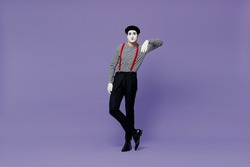 Full size body length confident young mime man with white face mask wears striped shirt beret look camera lean on something invisible isolated on plain pastel light violet background studio portrait