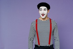 Smiling amazing marvelous blithesome young mime man with white face mask wears striped shirt beret looking aside keep mouth wide open isolated on plain pastel light violet background studio portrait
