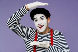 Charismatic crazy amusing amazing young mime man with white face mask wears striped shirt beret making hands photo frame box gesture isolated on plain pastel light violet background studio portrait