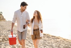 Happy young couple two friend family man woman in white clothes drink beer hold bag refrigerator have picnic rest together at sunrise over sea beach ocean outdoor seaside in summer day sunset evening
